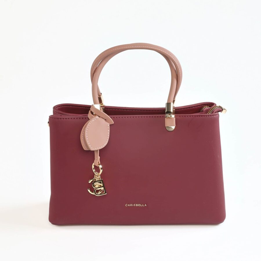 Sac à main en cuir rose et bordeaux, élégant et tendance..