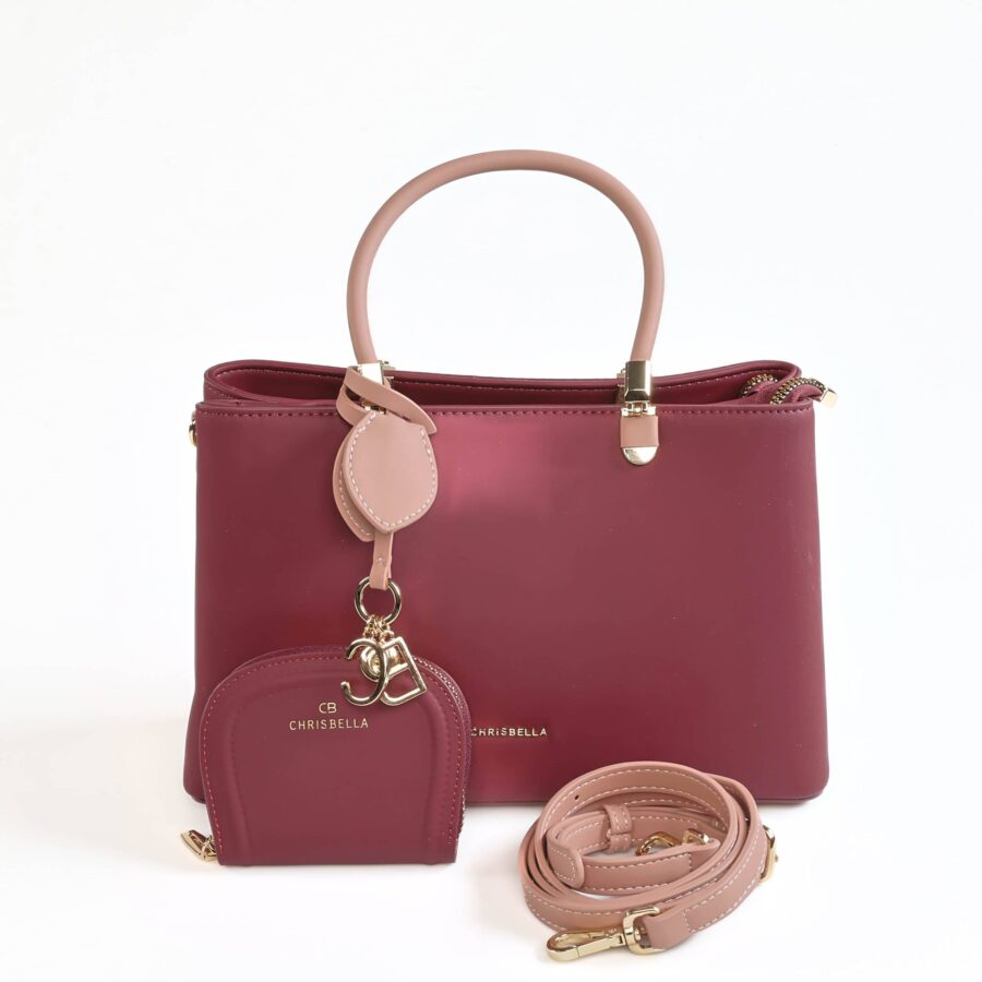 Sac à main en cuir rose foncé avec porte-monnaie et bandoulière assortie, idéal pour un style chic e..