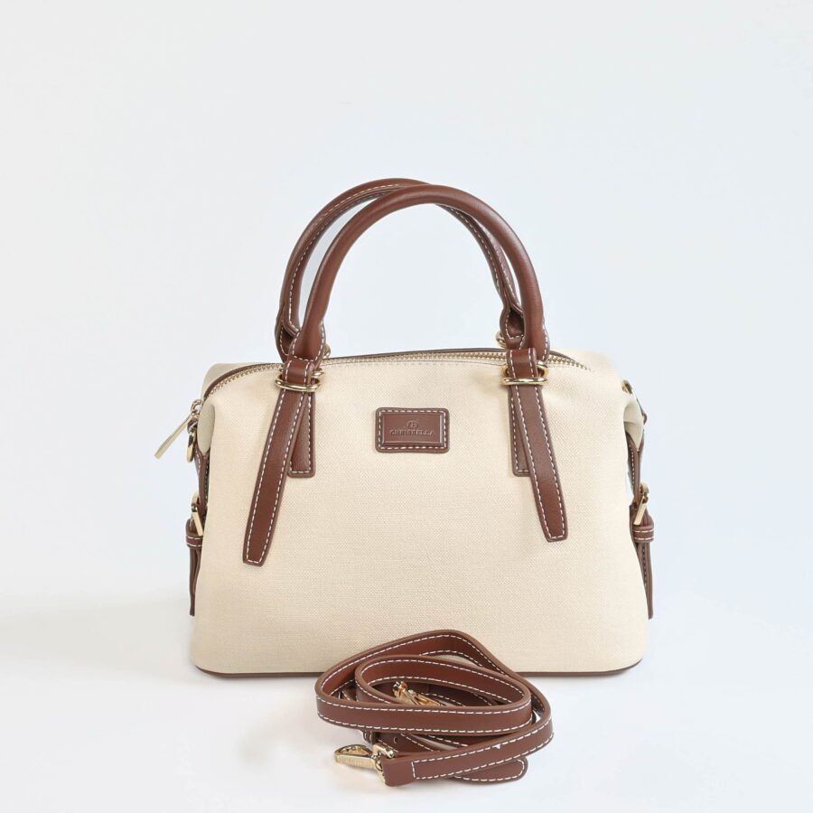Sac à main en cuir beige avec poignées marron et bandoulière amovible, parfait pour un style élégant..