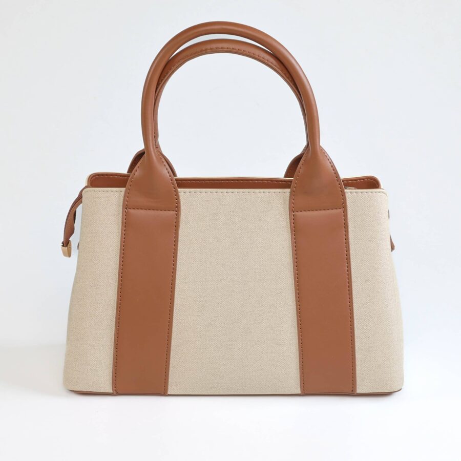 Sac à main en toile beige avec poignées en cuir marron clair, élégant et pratique..
